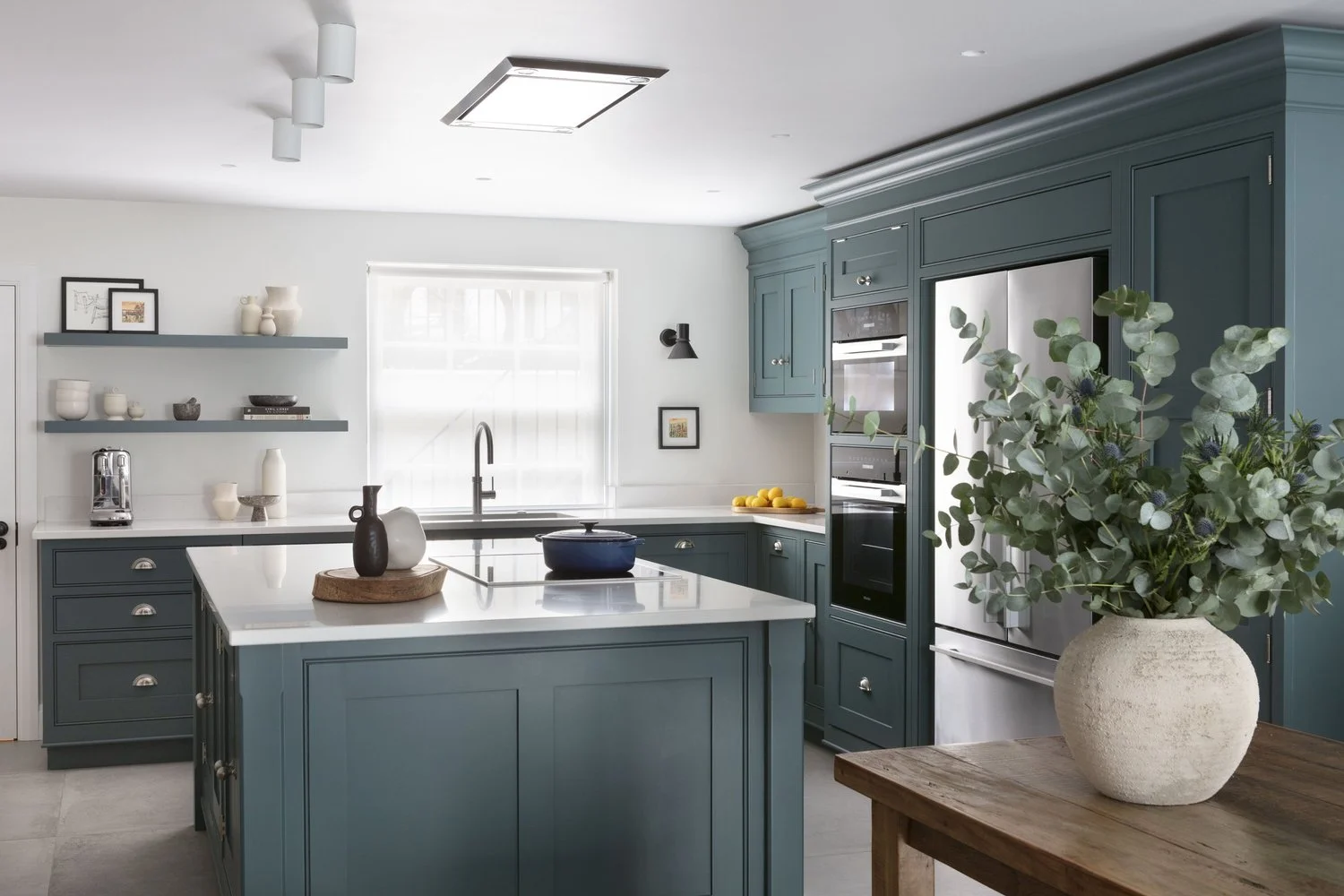 A green kitchen, quiet living spaces and a wine store tucked beneath the stairs.