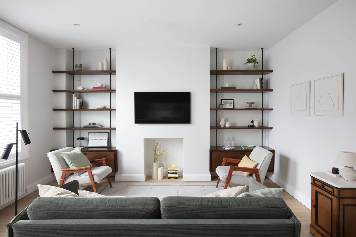Open shelves for collected objects, with a separate place to work beside the window.